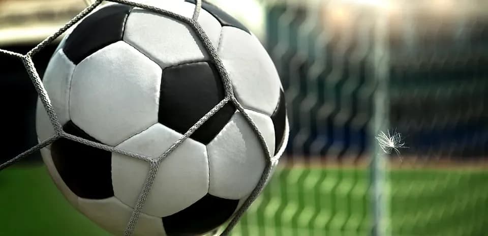 Soccer ball in the net after scoring a goal