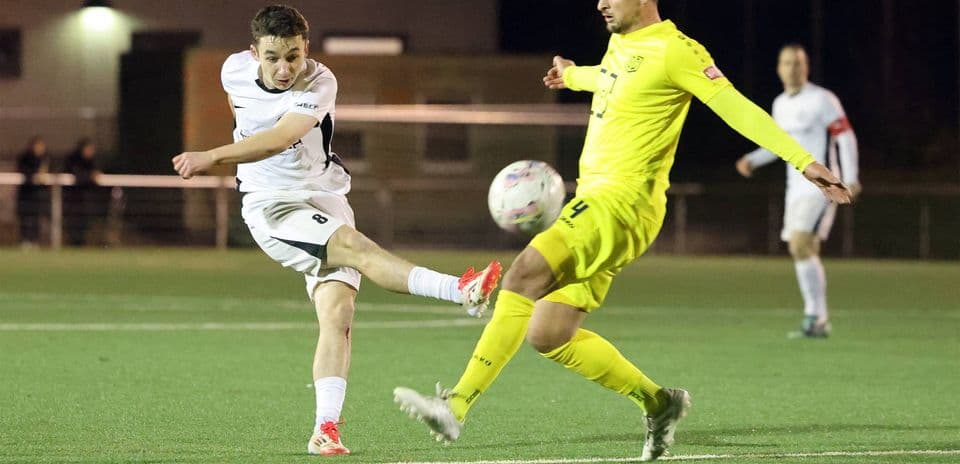 Player kicking the ball during SC St. Tönis match