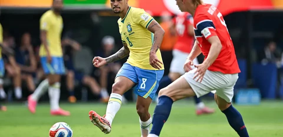 Brazilian player dribbling past opponent during match