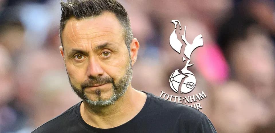 Coach standing with Tottenham Hotspur logo in background
