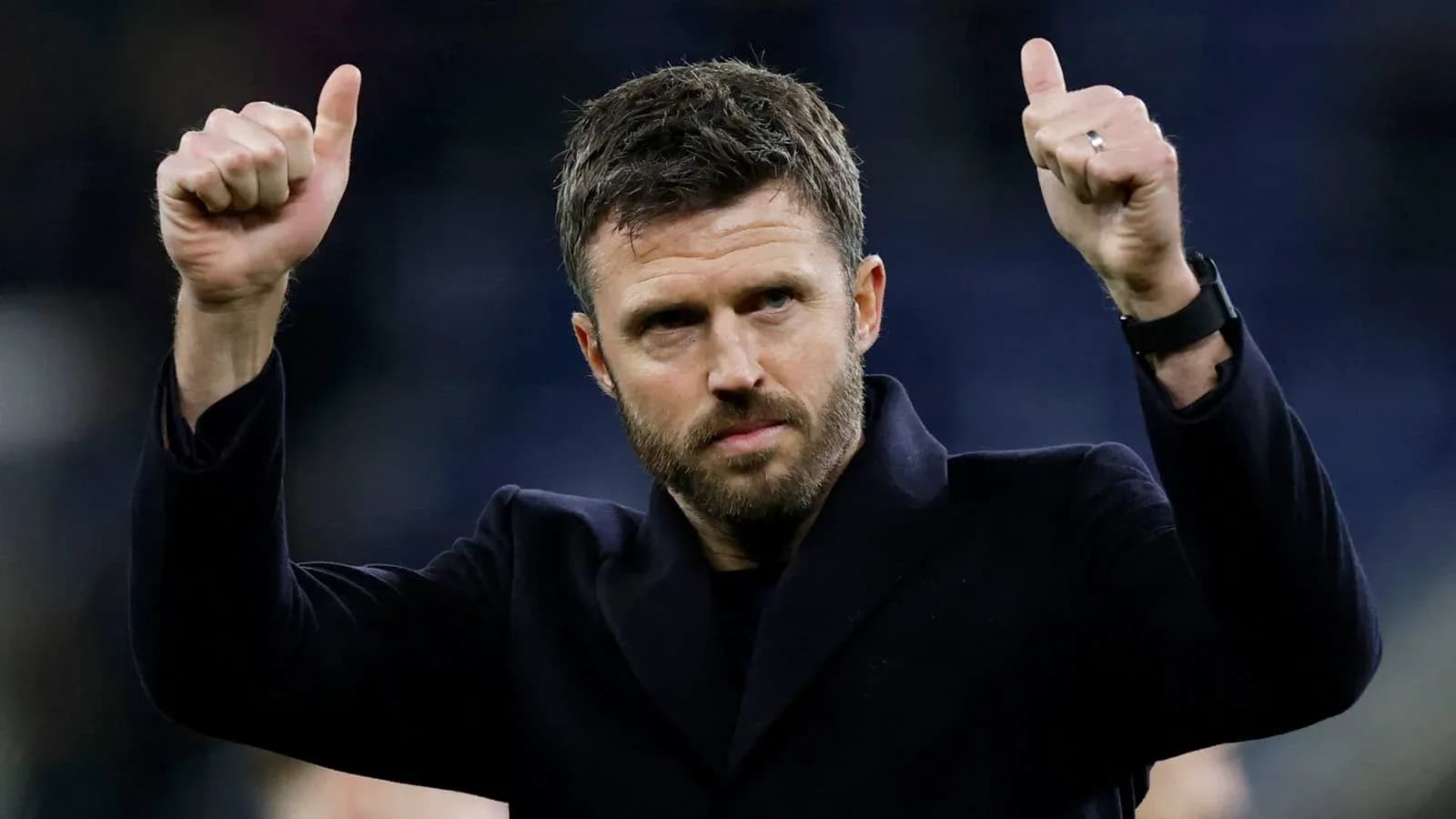 Man giving thumbs up gesture on the field