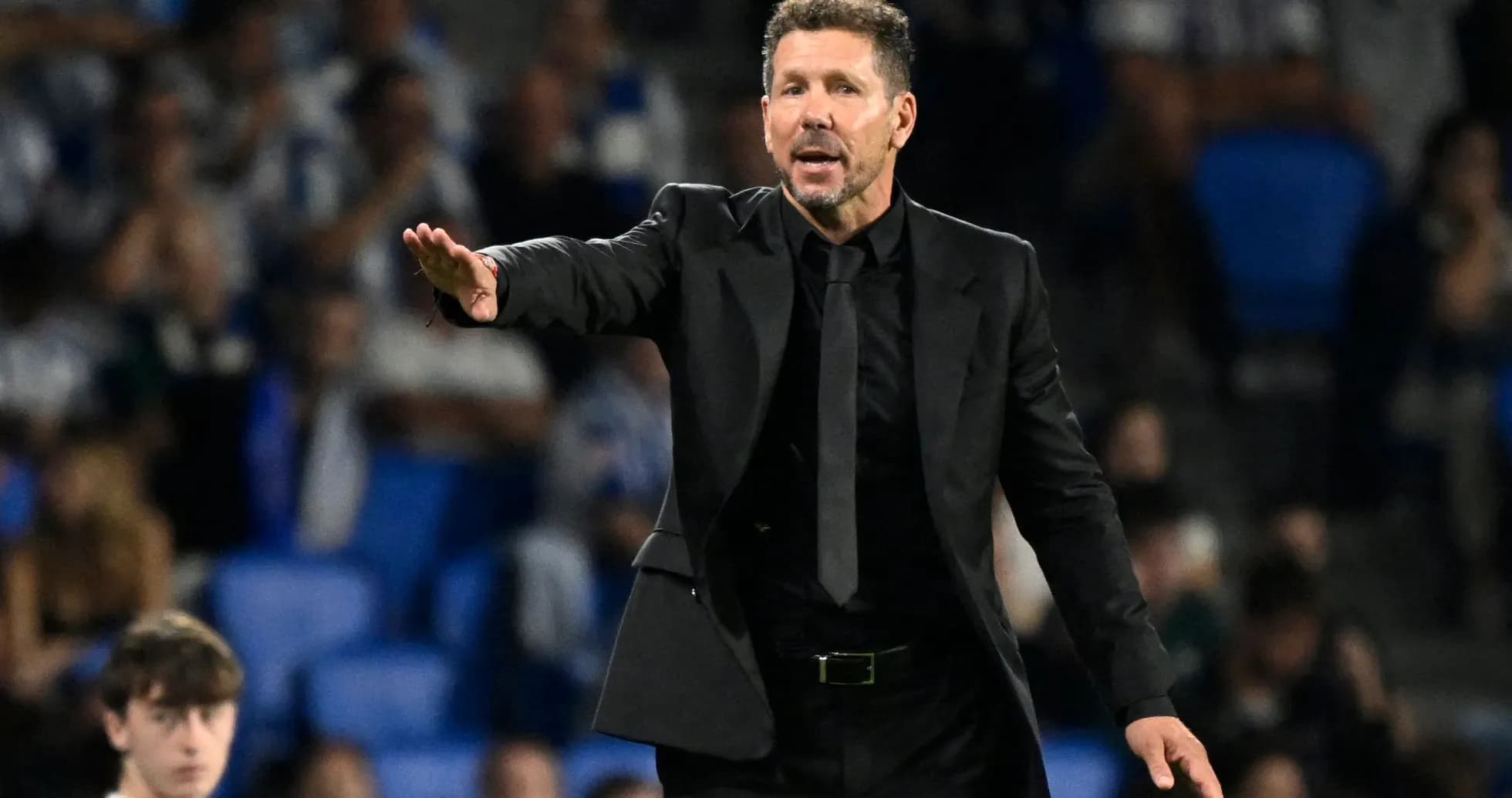 Coach giving instructions during a football match