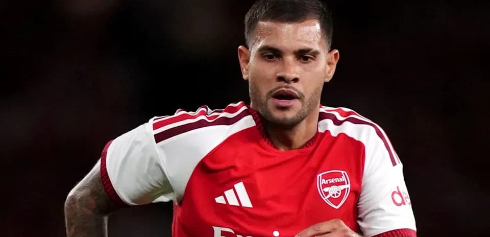Player in Arsenal kit running on the field