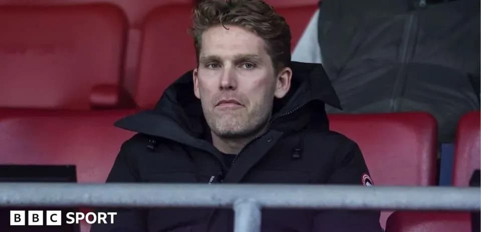 Man sitting in stadium seats during match