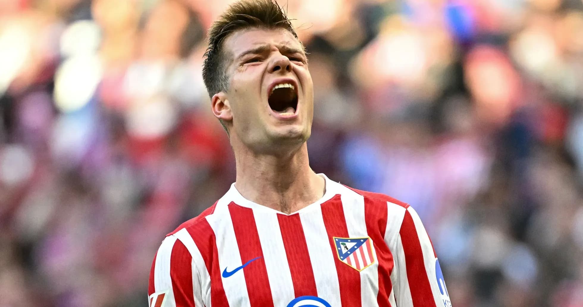 Player celebrating passionately during match for Atlético Madrid