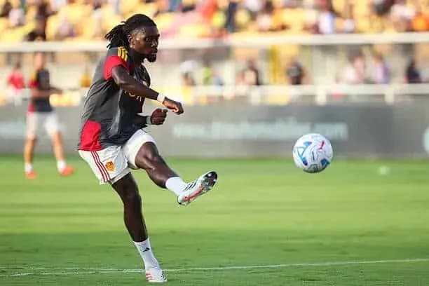 Player kicking a soccer ball during warm-up session