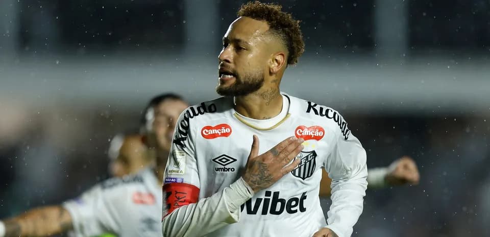 Player celebrating a goal during a rainy match