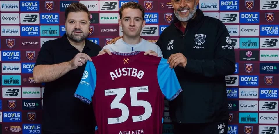 Player holding jersey with name Austbø during signing