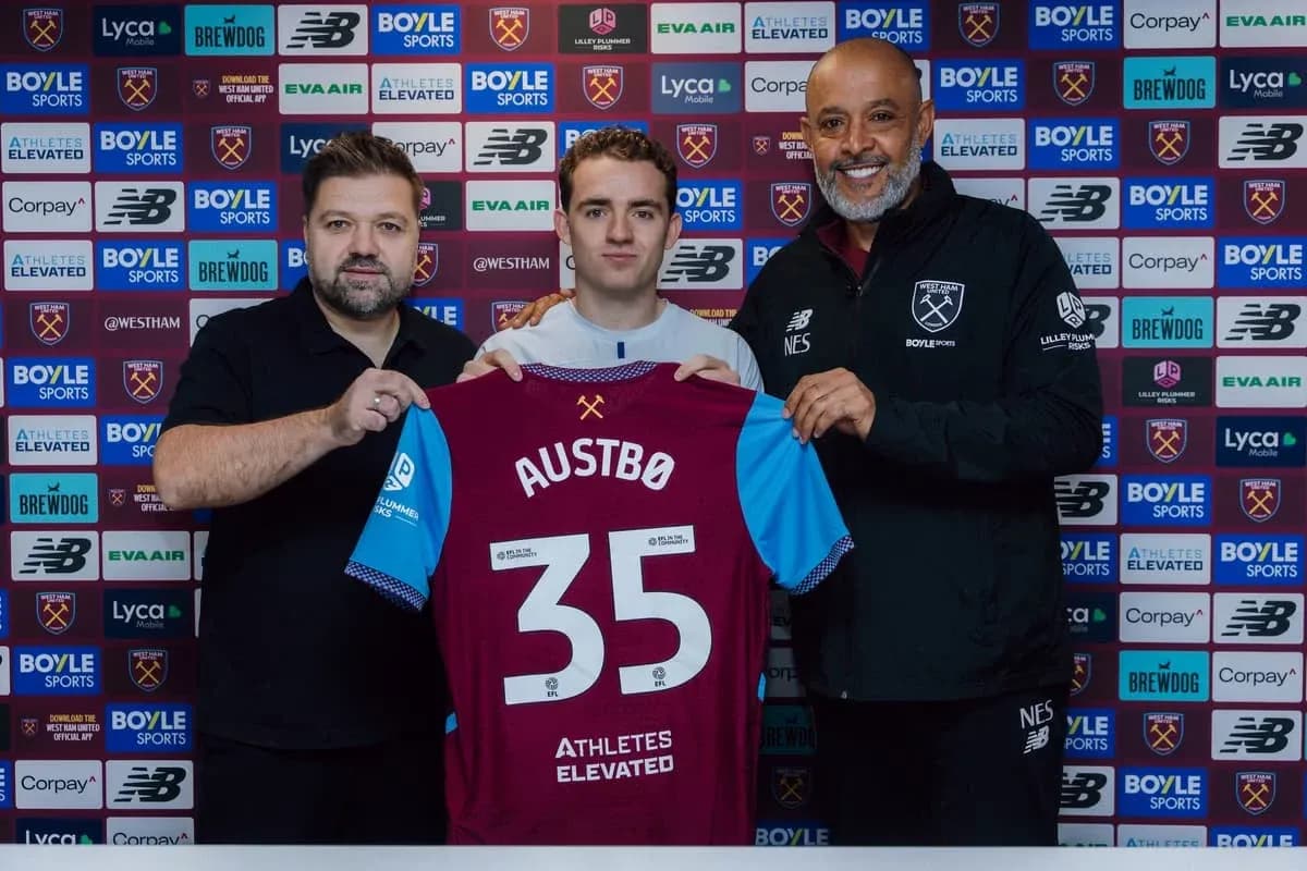 Player holding jersey with name Austbø during signing