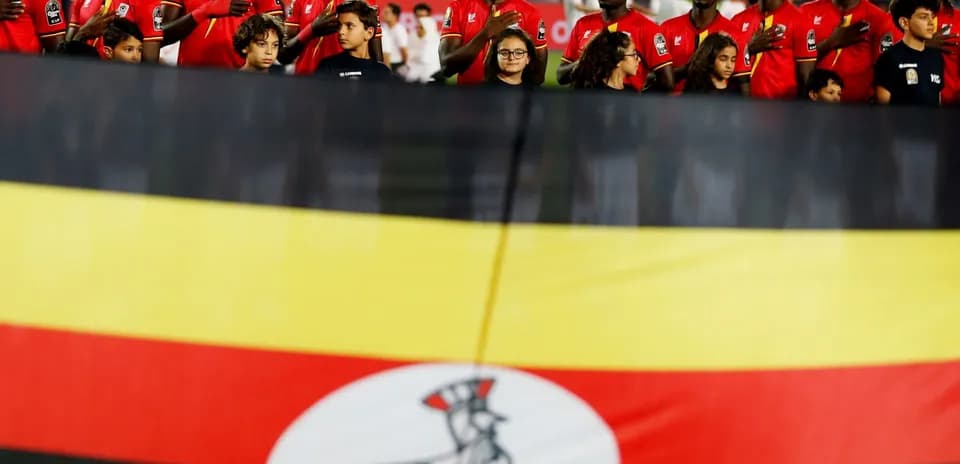Ugandan team members standing before a match