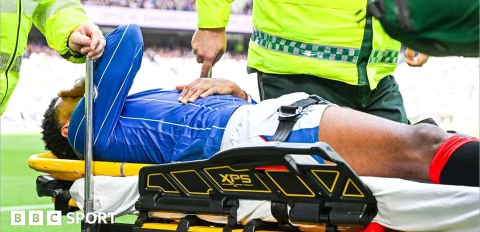 Player being treated on stretcher by medical staff