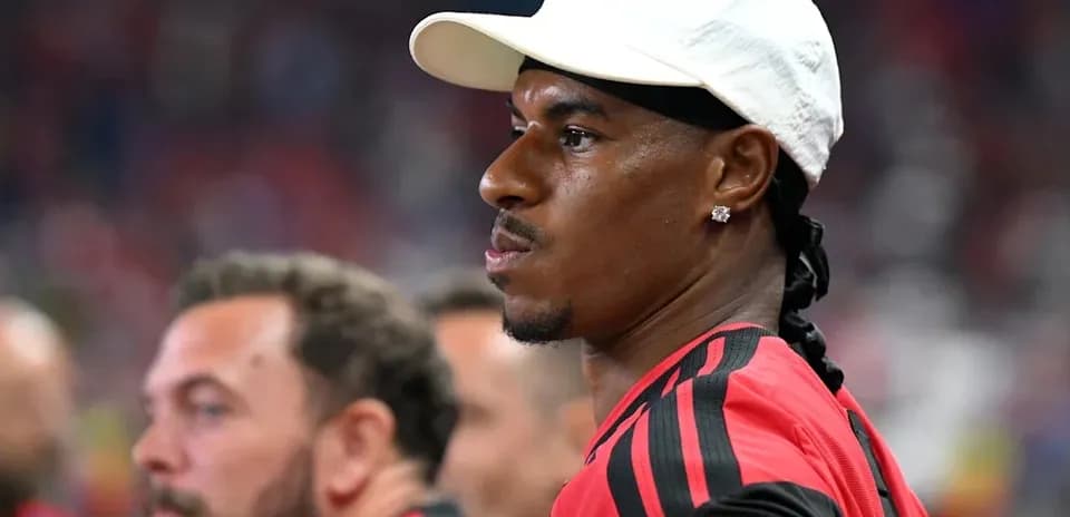 Player wearing a cap on the sidelines during match