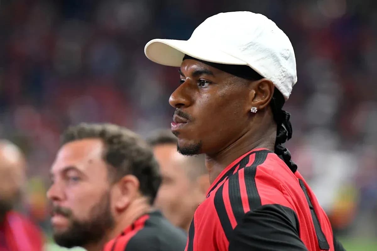 Player wearing a cap on the sidelines during match