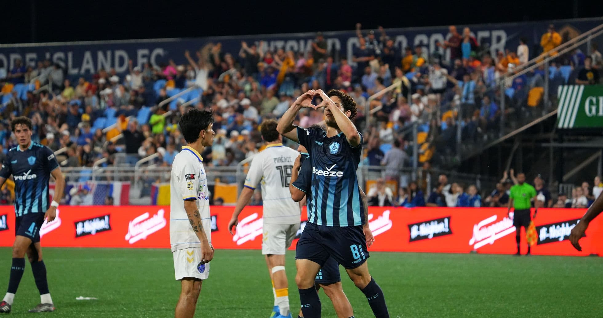 Player celebrating a goal during Rhode Island match