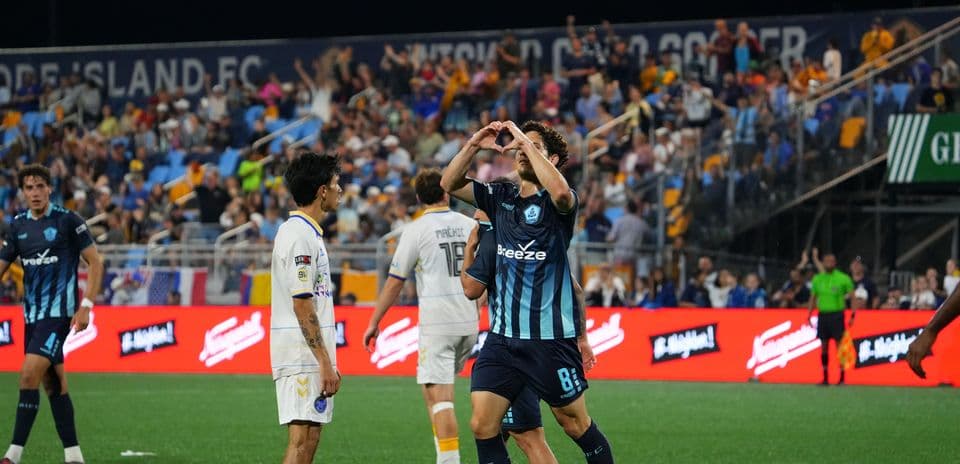 Player celebrating a goal during Rhode Island match