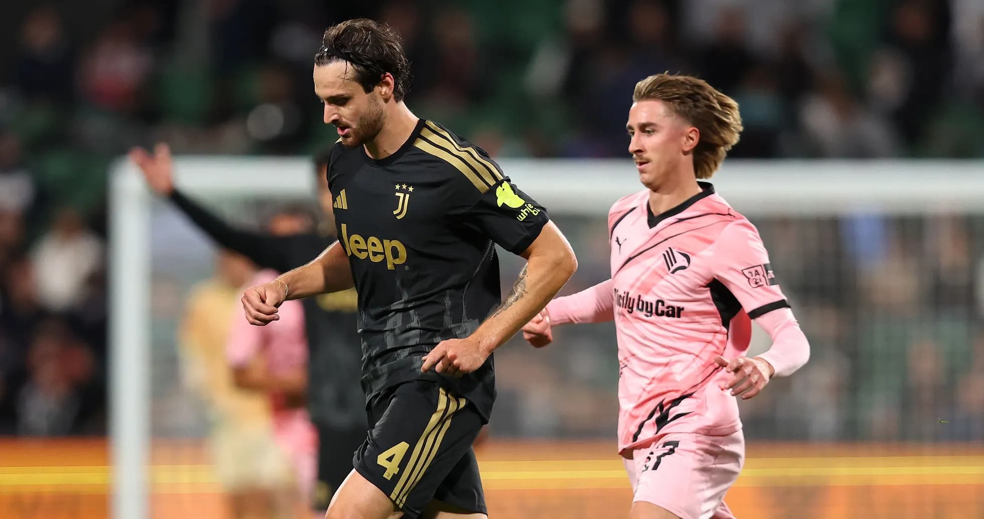 Juventus player running with opposing player nearby