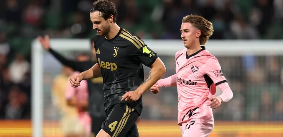 Juventus player running with opposing player nearby