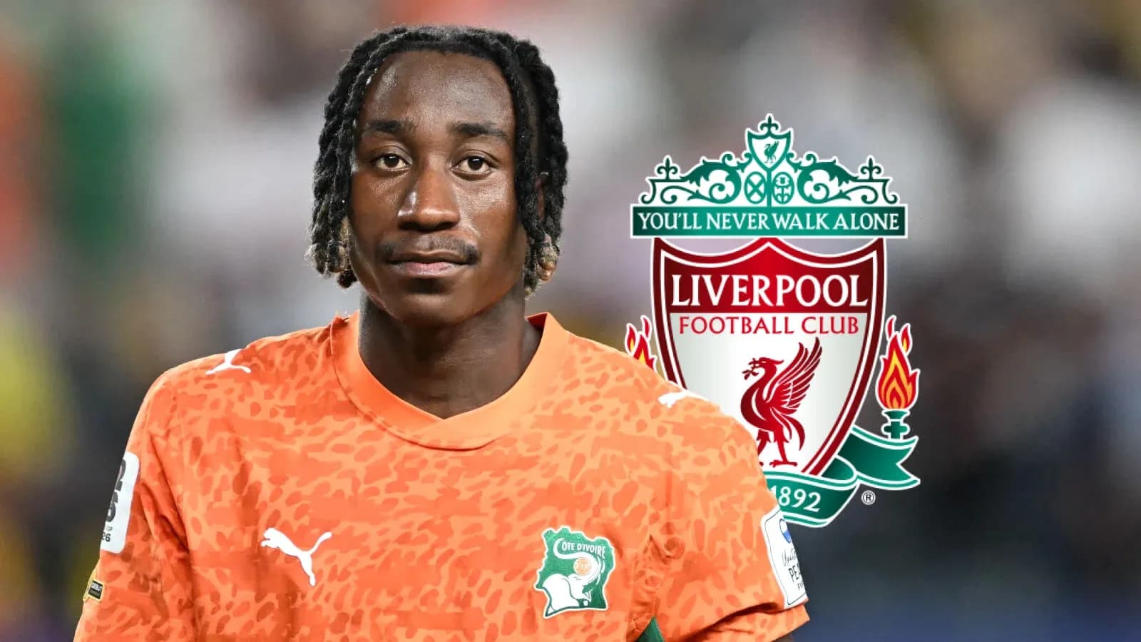 Goalkeeper in orange jersey with Liverpool logo