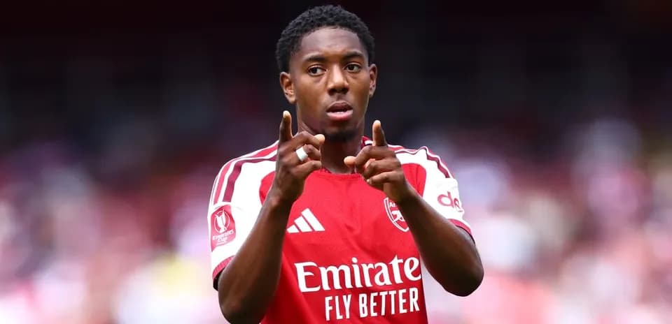 Player gesturing during match in Arsenal jersey
