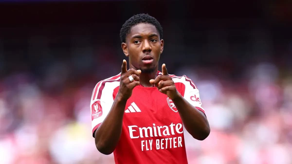 Player gesturing during match in Arsenal jersey
