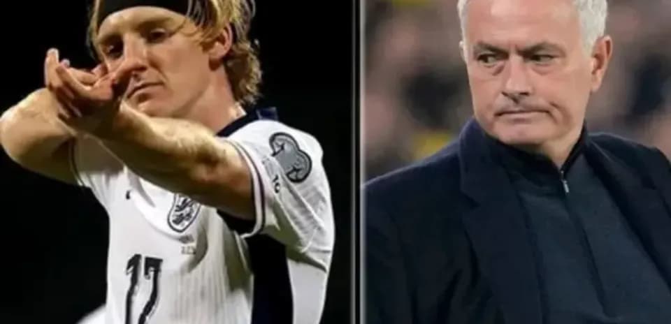 Player celebrating and manager observing during match