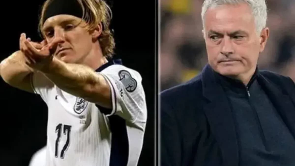 Player celebrating and manager observing during match