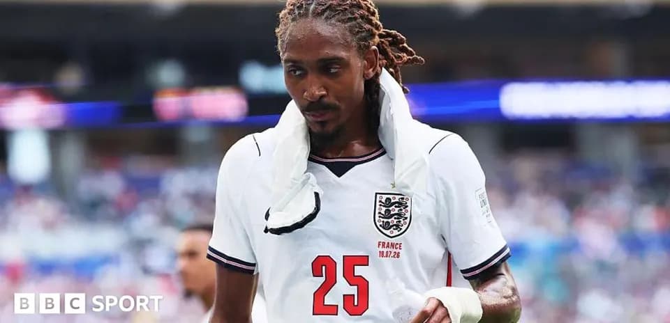 Player wearing England jersey walking off the pitch
