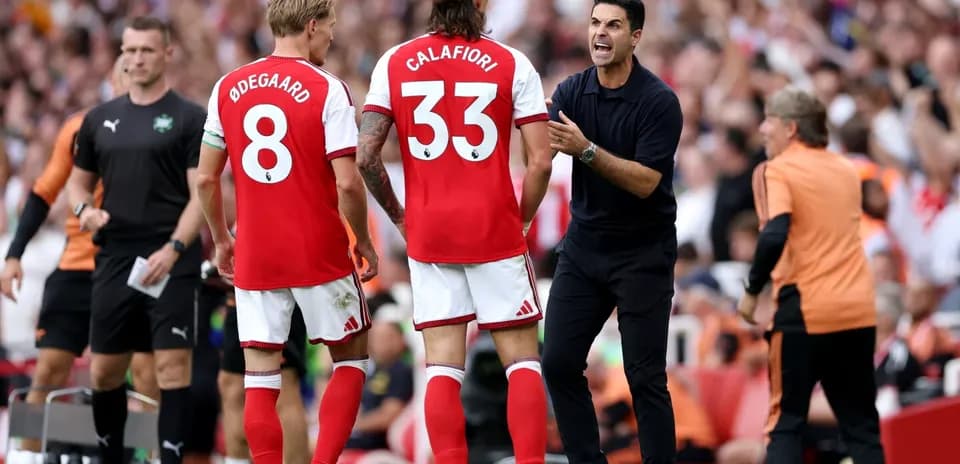 Arsenal players and manager during a substitution