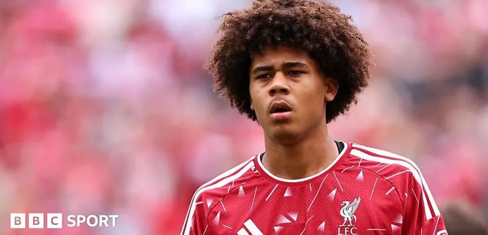 Young player in Liverpool jersey on field
