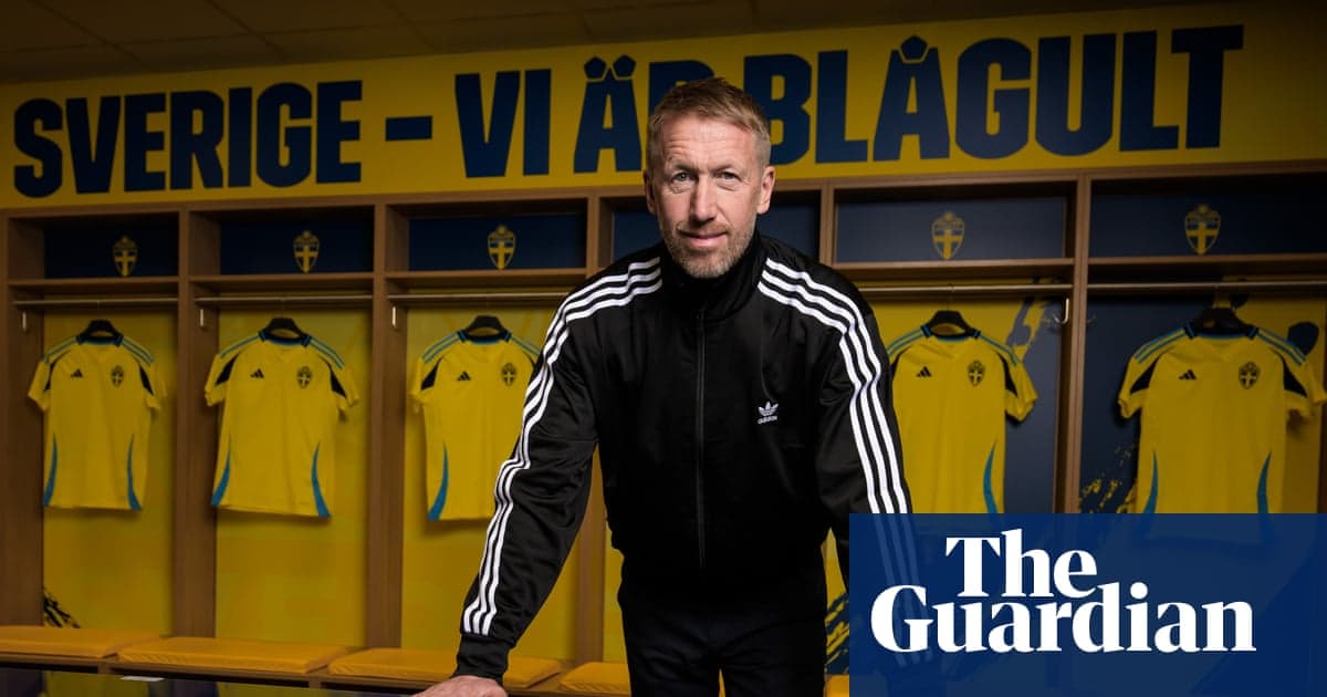 Coach standing in front of Swedish team jerseys