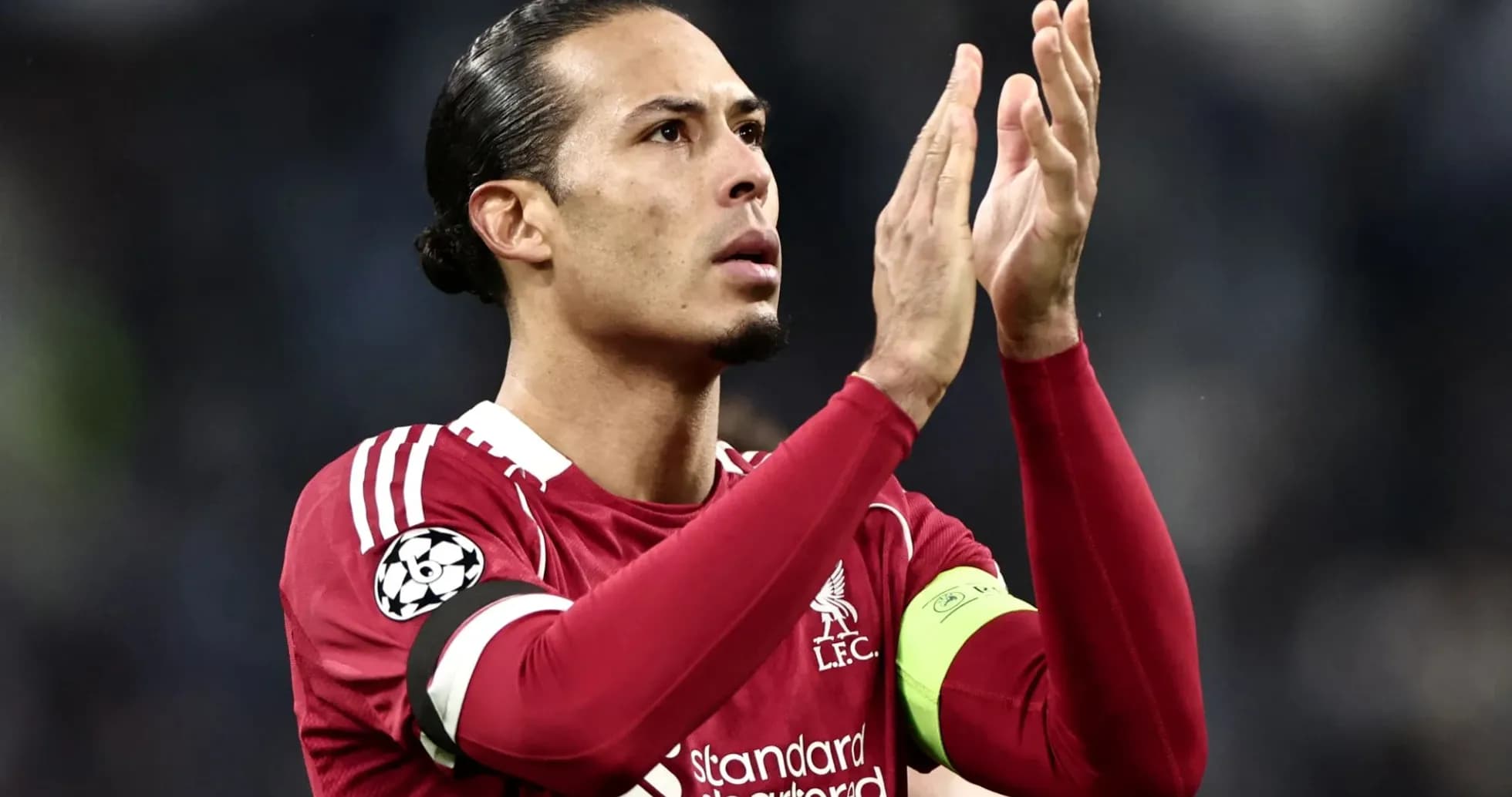 Player applauding fans in Liverpool kit during match