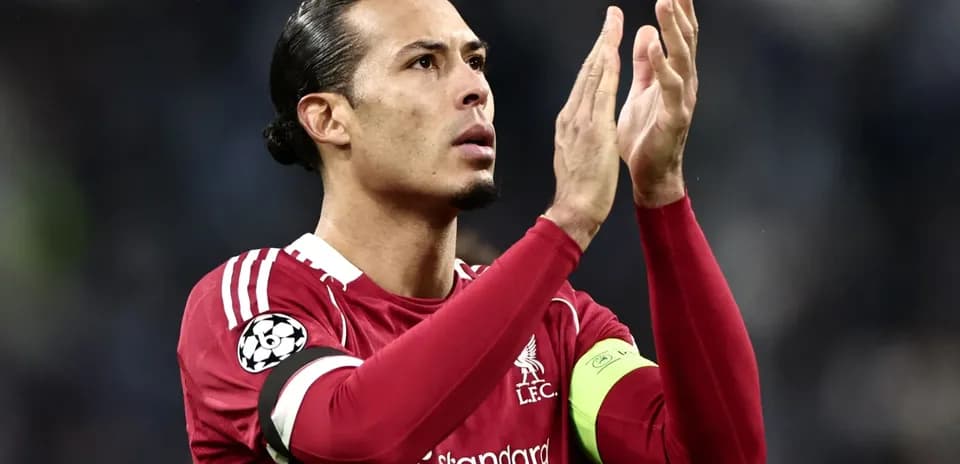 Player applauding fans in Liverpool kit during match