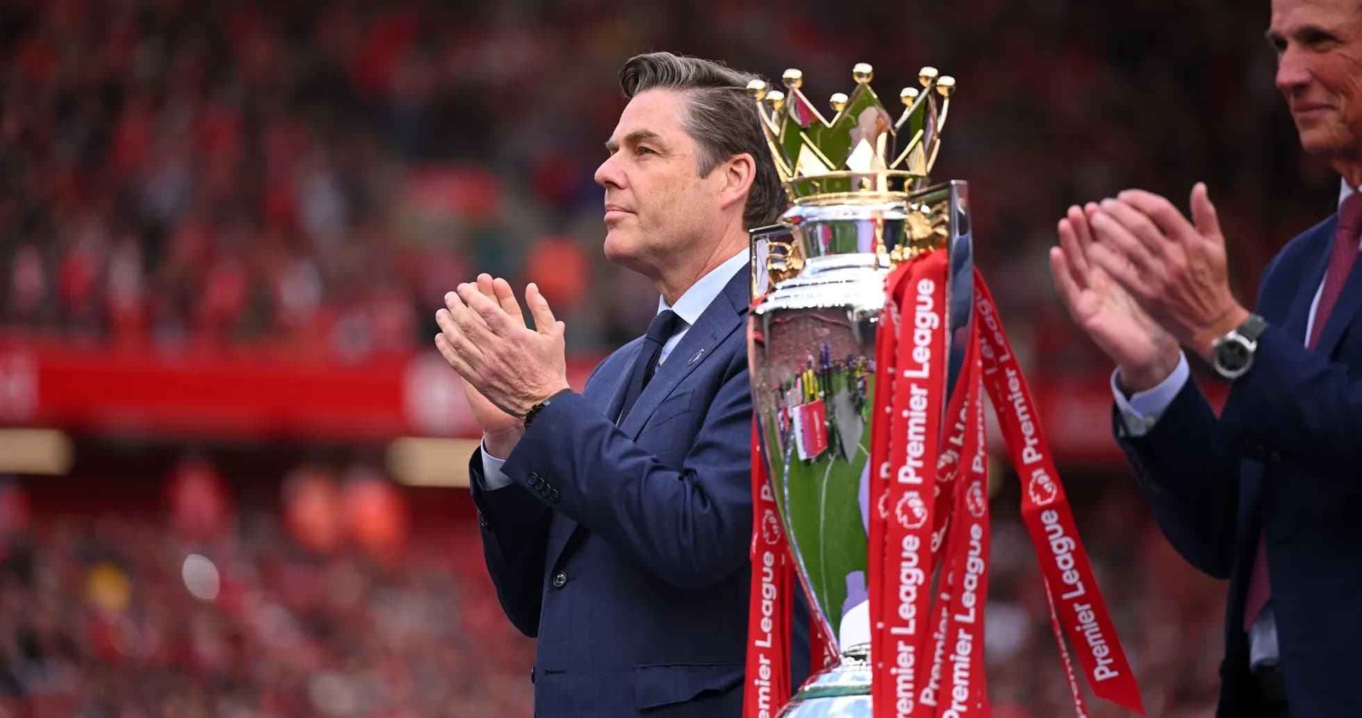 Official presenting Premier League trophy at ceremony