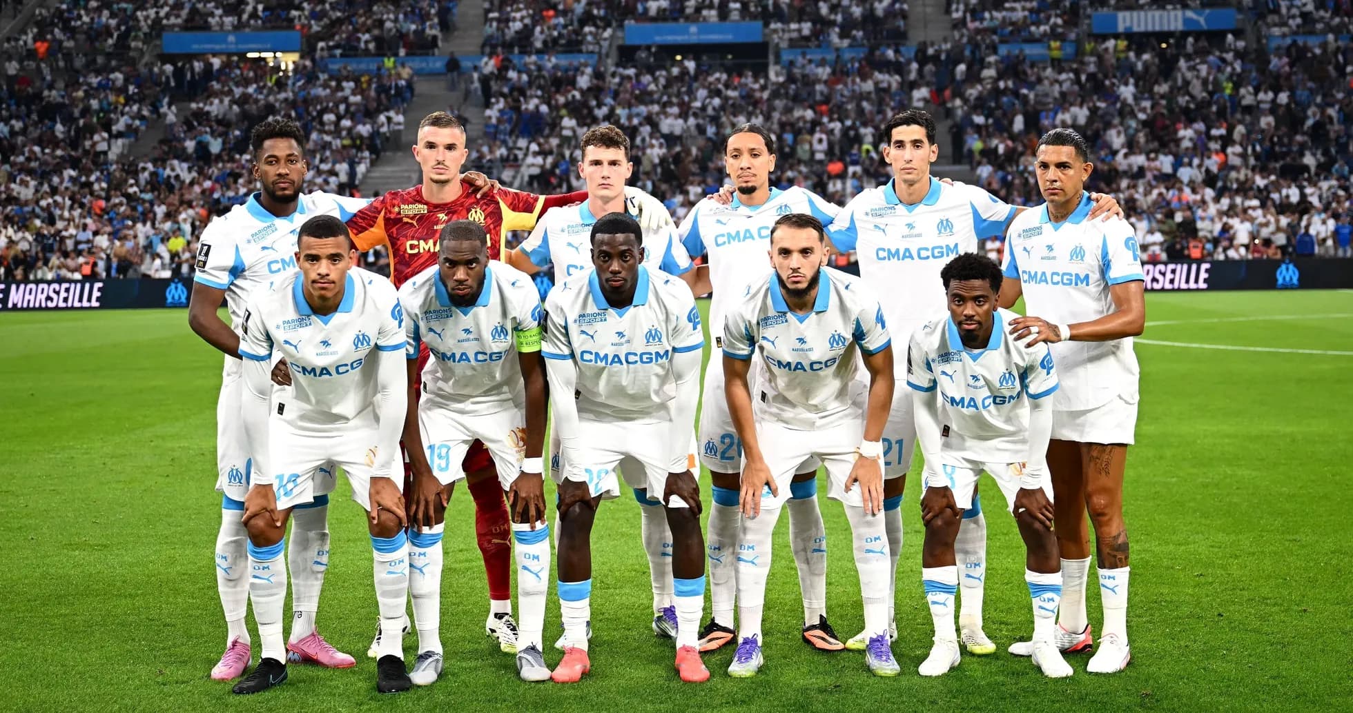 Olympique Marseille team posing on the pitch