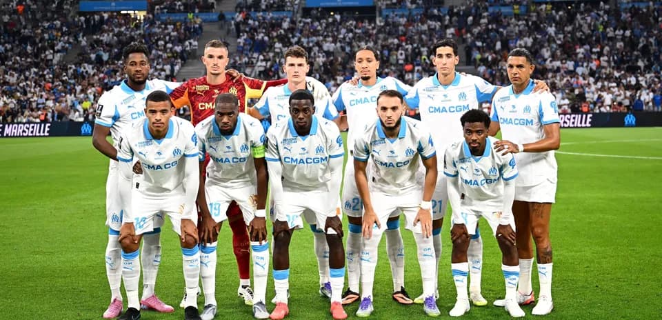 Olympique Marseille team posing on the pitch