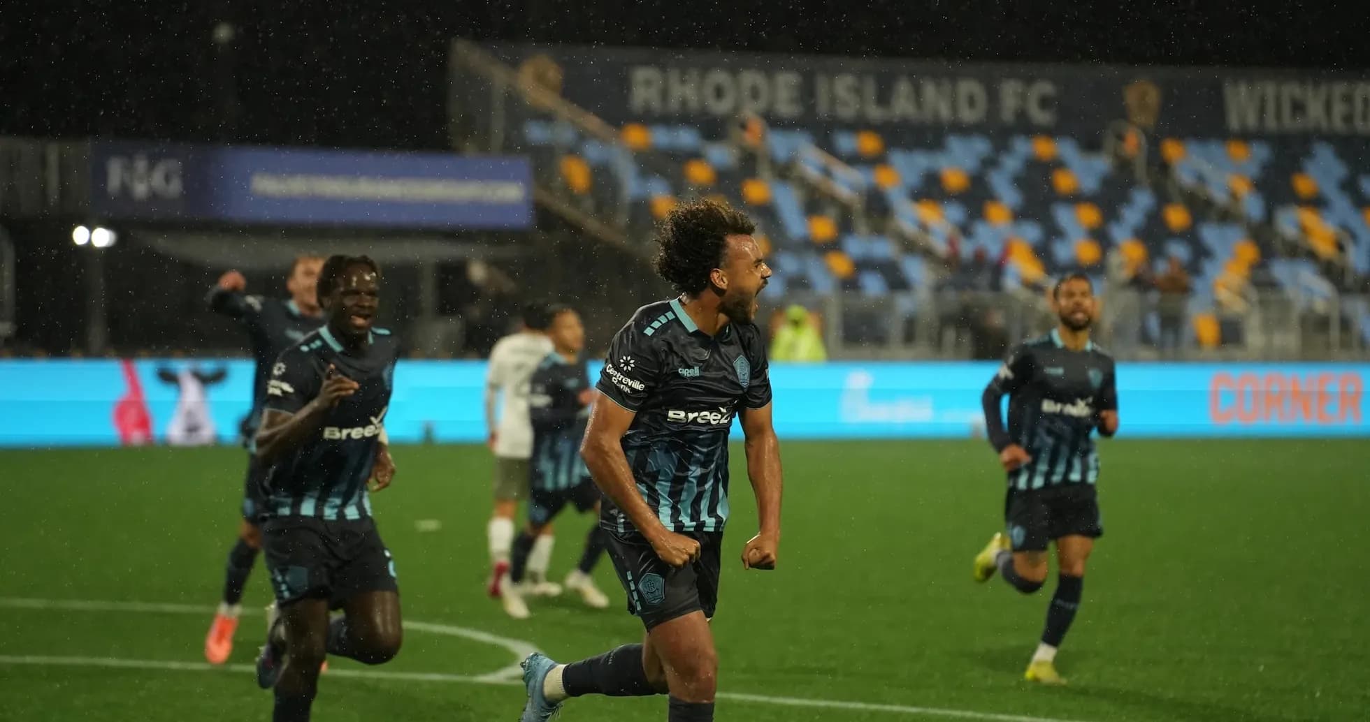 Rhode Island player celebrating a goal in match