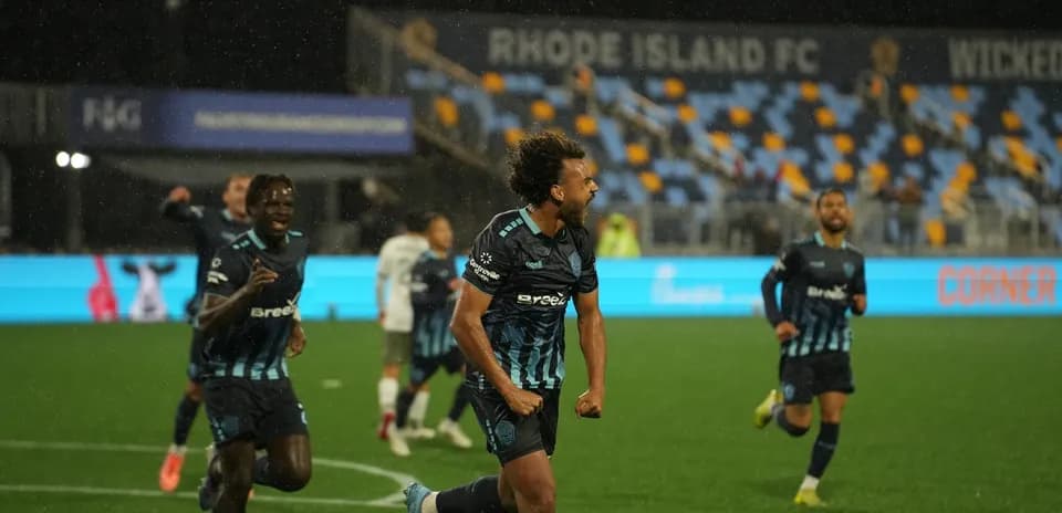Rhode Island player celebrating a goal in match
