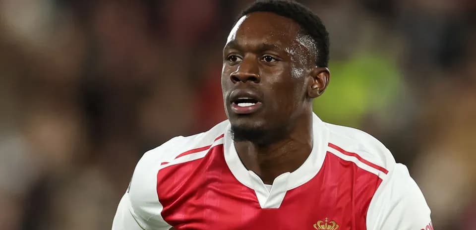 Player in AS Monaco kit running on the field