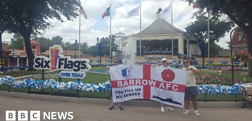Fans holding Barrow AFC flag at Six Flags Texas