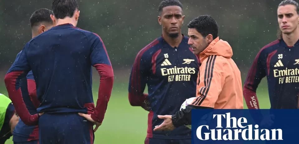Arsenal manager discussing tactics with players during training