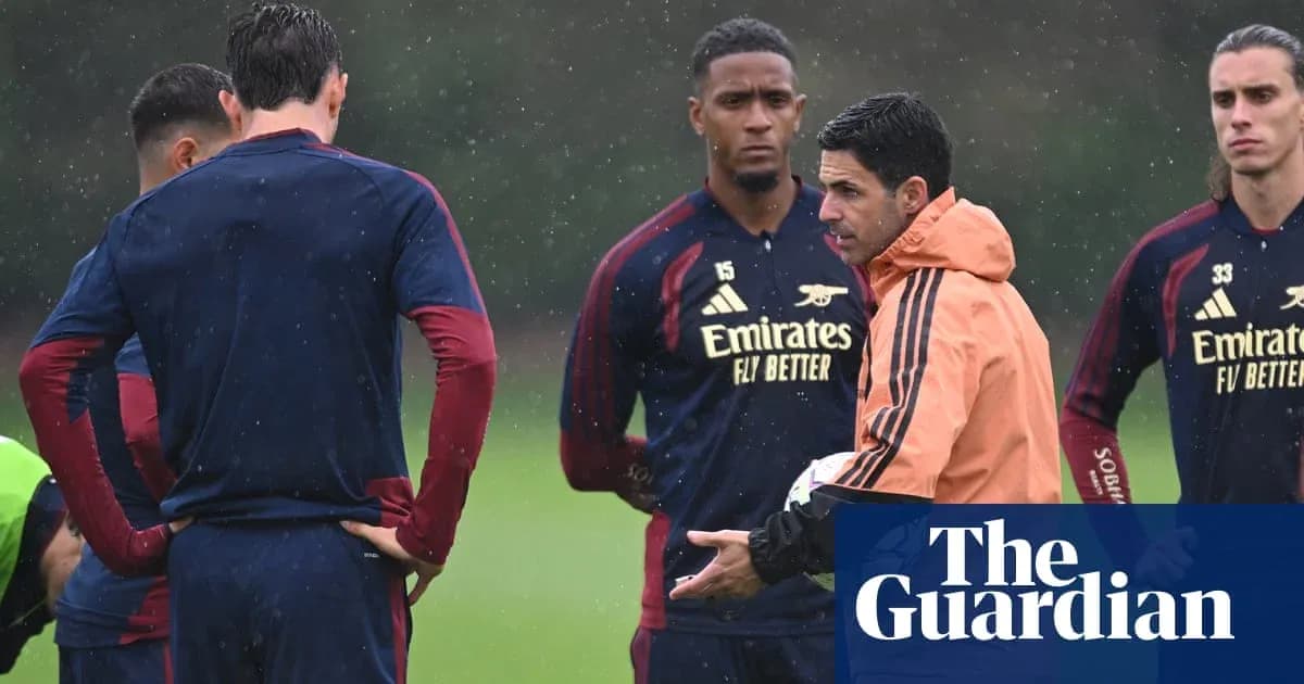 Arsenal manager discussing tactics with players during training