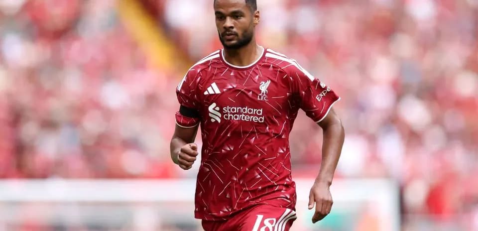 Player walking on the pitch in Liverpool kit