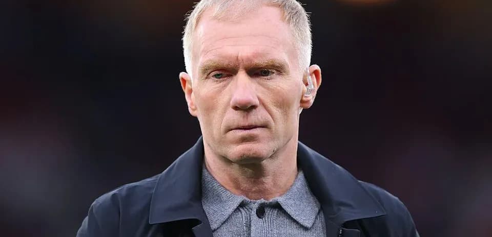 Man wearing a dark coat and gray shirt