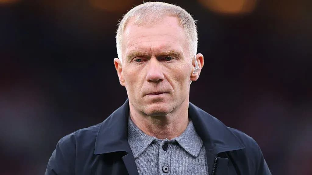 Man wearing a dark coat and gray shirt