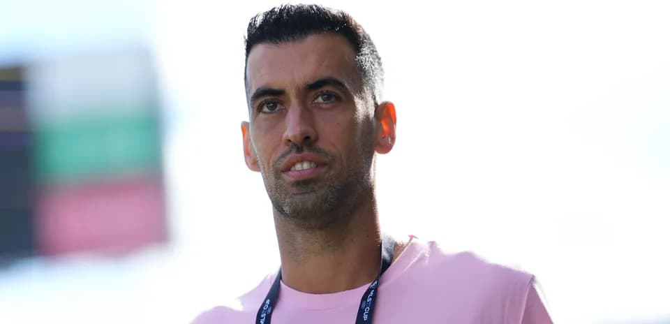 Player in pink shirt at stadium entrance