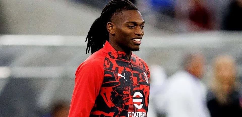 Player smiling while wearing training jacket