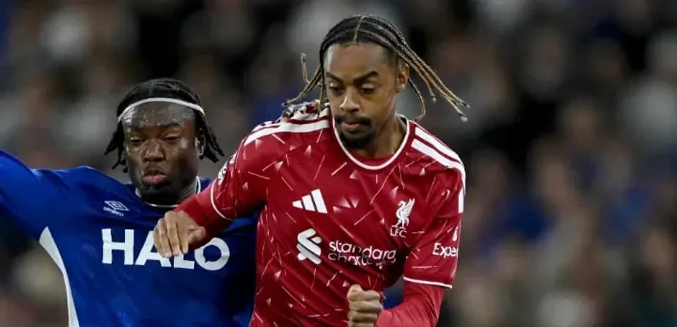 Liverpool player evading challenge from opponent