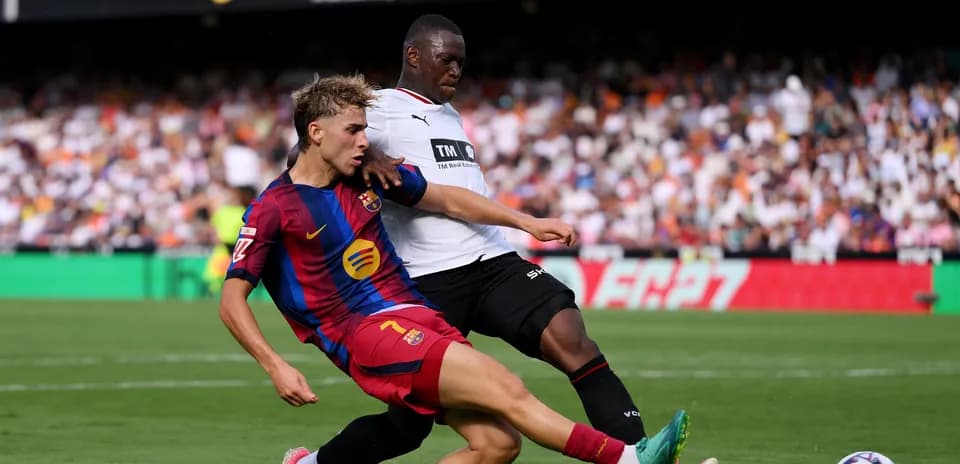Barcelona player challenged by opponent during match
