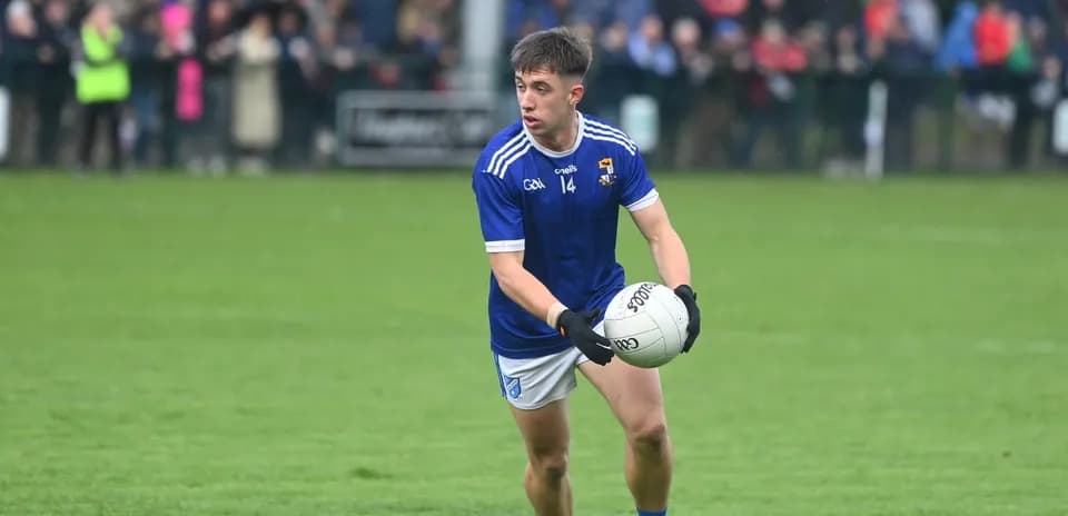 Player in blue jersey holding football during match