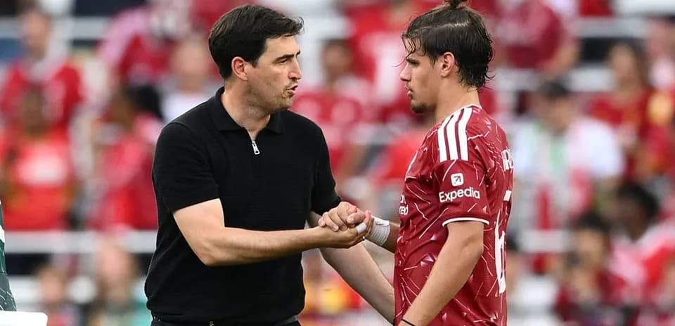 Coach discussing strategy with player during match